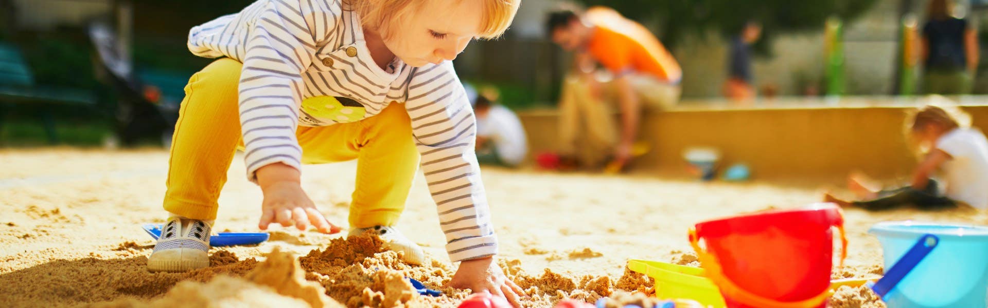  child playing in sandpit 